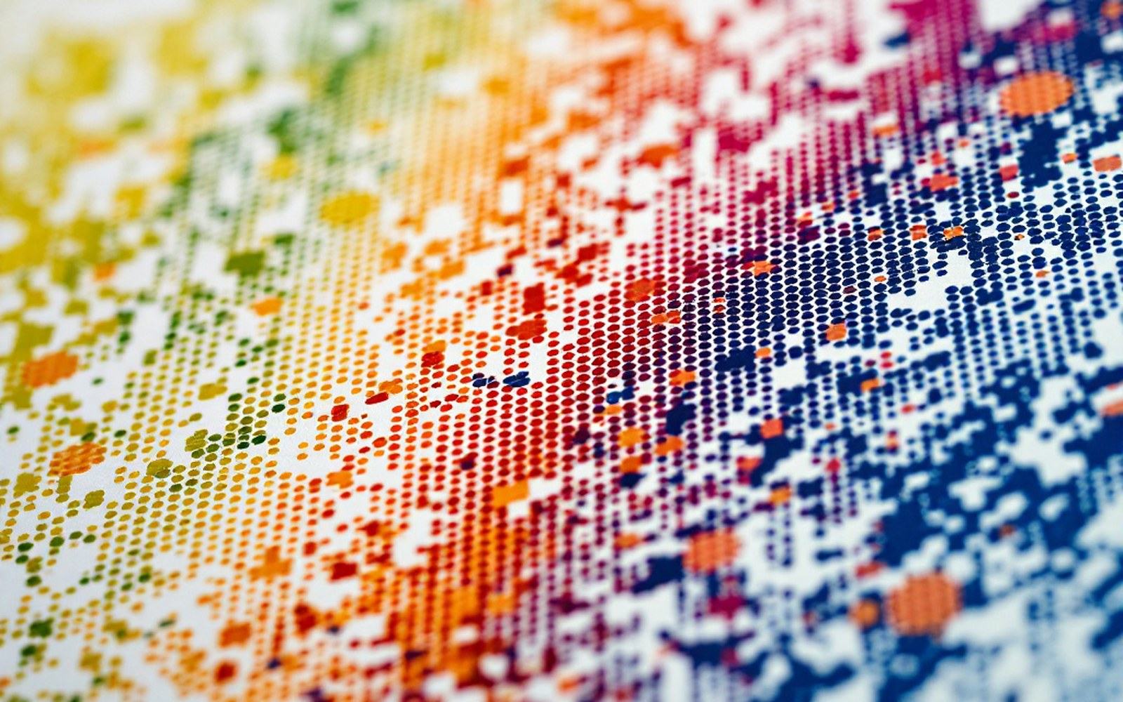 An extreme close view of printed colour showing individual halftone dots on rough paper